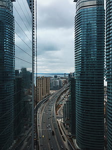 black concrete road in the middle on black buildings thumbnail