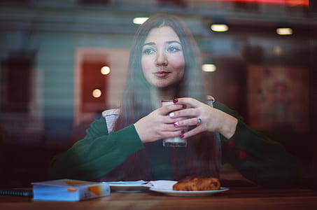 woman holding glass cup thumbnail