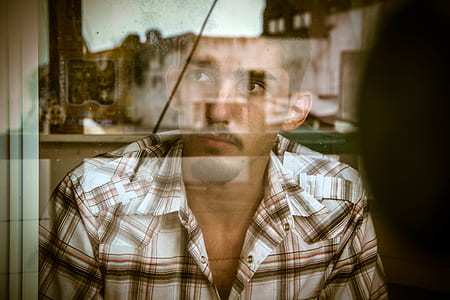 man staring on windowpane thumbnail