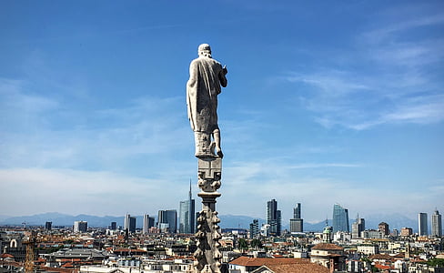 statue on column near buildings thumbnail