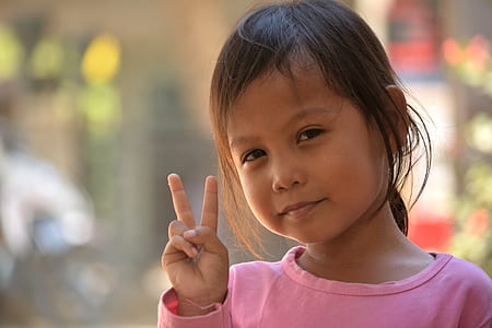 girl doing peace sign hand gesture thumbnail