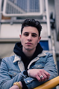 man wearing denim jacket and leaning on bar thumbnail