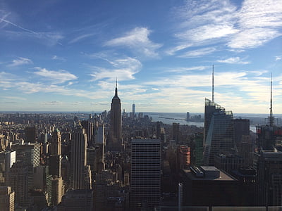 city buildings under blue clouds thumbnail