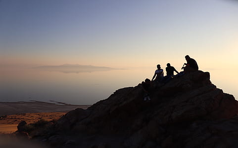 silhouette of three person on mountain thumbnail