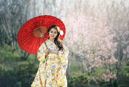 person in yellow dress holding red umbrella thumbnail