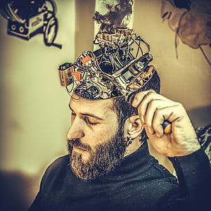 shallow focus photography of a man holding black metal device thumbnail