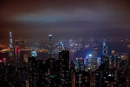 lighted highrise building near river during night time thumbnail