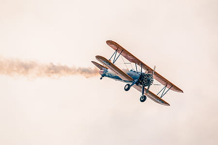 blue and brown airplane on sky under clear white sky at daytime thumbnail