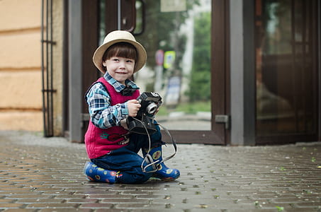 bot sitting on floor holding camera thumbnail