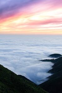 mountain ridge and sea of clouds during golden hour thumbnail