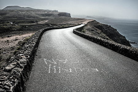 grayscale photography of road near ocean thumbnail