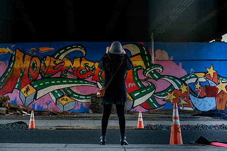 woman standing in front of the wall thumbnail