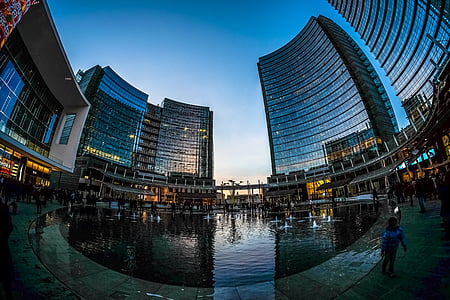 fish eye camera shot of body of water surrounded by high rise buildings thumbnail