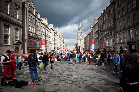 group of people standing on street in between buildings thumbnail