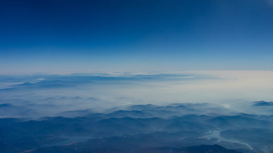 aerial view photography of mountain under blue sky thumbnail