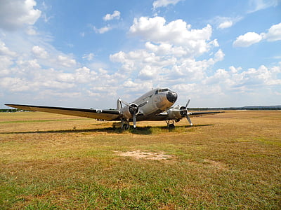 white plane on green field during daytime thumbnail