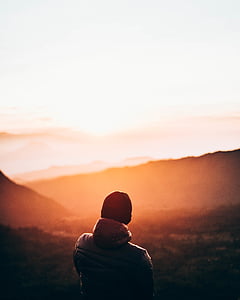 man wearing jacket in front of mountain thumbnail