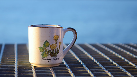 selective focus photography of white and green floral mug thumbnail