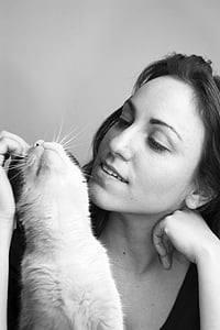 woman playing with cat in gray-scale photography thumbnail