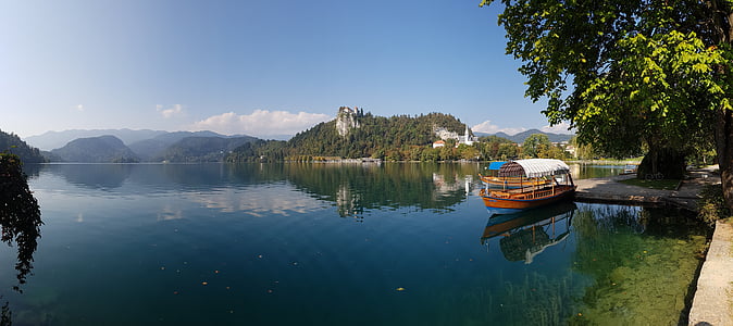 boat parked near dock during daytime thumbnail