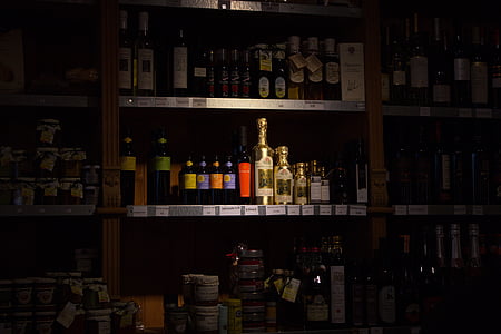 assorted beverage bottle on wooden rack thumbnail