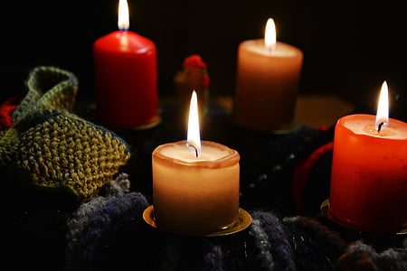 four red and beige pillar candles lighted up thumbnail