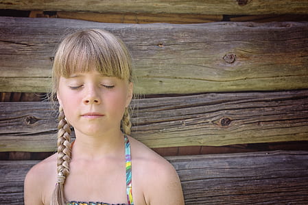 woman beside wooden wall thumbnail