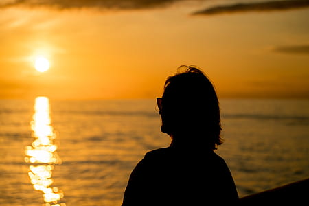 silhouette of woman looking through sea thumbnail