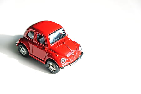 red Volkswagen Beetle coupe scale model on white surface thumbnail