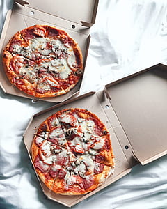 two pizzas on boxes thumbnail