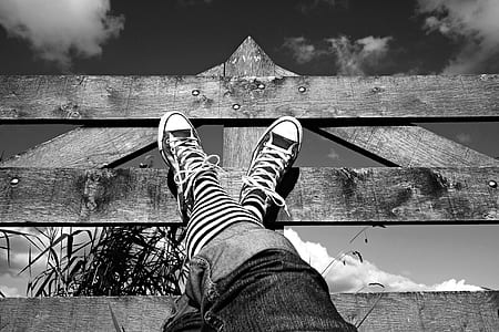 grayscale photography of crossing legs thumbnail
