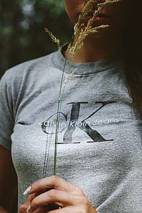 Woman in a grey crop top shirt holding wheat thumbnail
