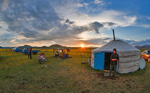 people camping on green grass field thumbnail