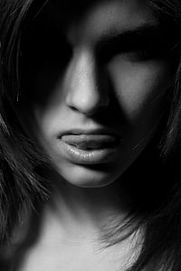 grayscale photo of woman showing her tongue thumbnail