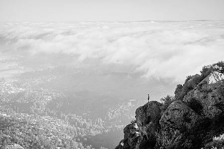 person standing at top of cliff thumbnail