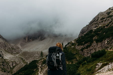 person standing on gray and green mountain thumbnail