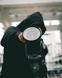 person holding black Canon EOS 5D thumbnail