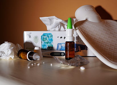 brown glass bottle on white wooden table thumbnail