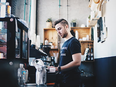 man standing in front of coffeemaker photograph thumbnail