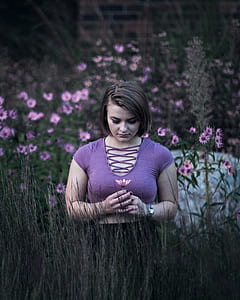 woman holding a pink petaled flowers thumbnail