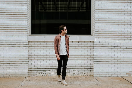 man standing in front of concrete building at daytime thumbnail