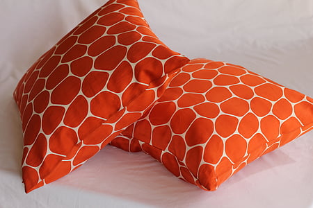 two orange-and-white throw pillows thumbnail