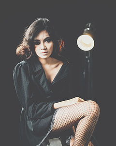 woman in black blazer with stocking near floor lamp thumbnail