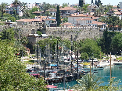 ships docked on shore near town thumbnail
