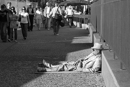 man wearing hat laying on floor thumbnail