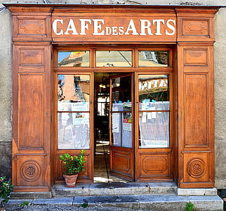 Cafe Des Arts with brown wooden opened door thumbnail