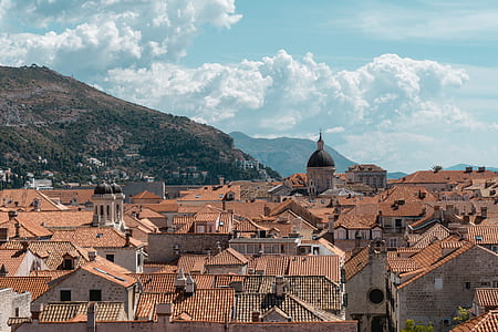 city near mountains during daytime thumbnail
