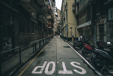 photo of gray concrete road between buildings thumbnail