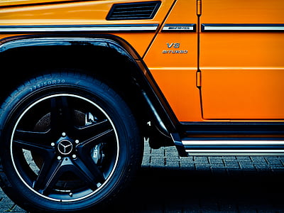orange Mercedes-Benz car on gray floor thumbnail