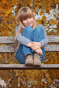 girl sitting on brown bench thumbnail